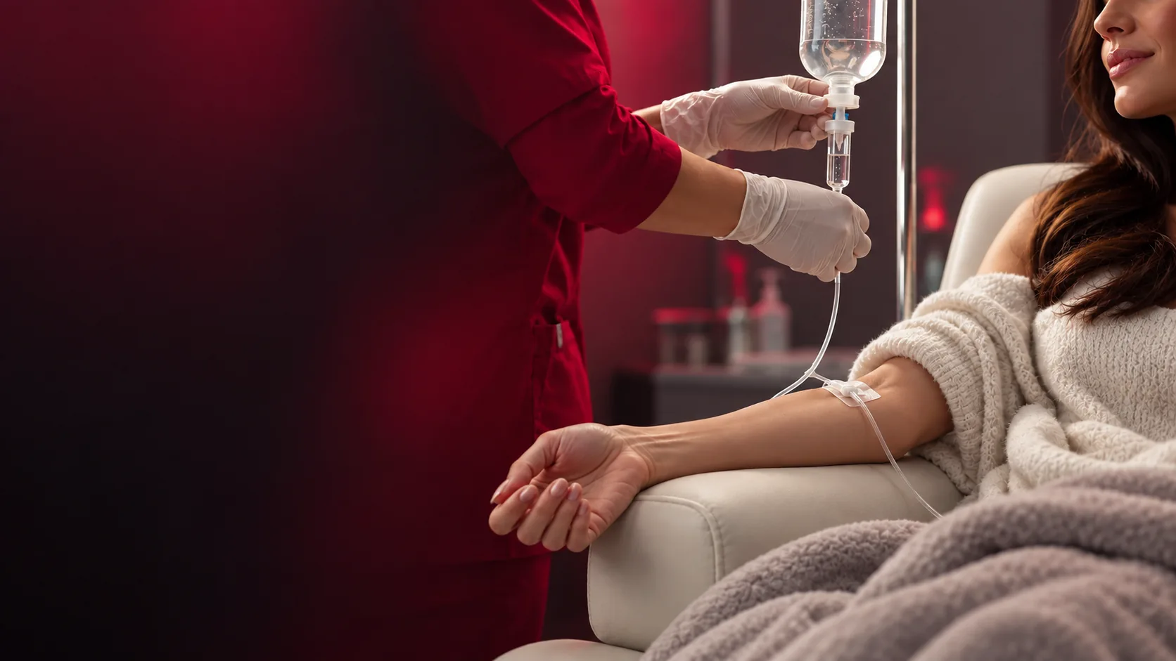 Patient reclining during IV drip therapy while a provider checks the IV line.