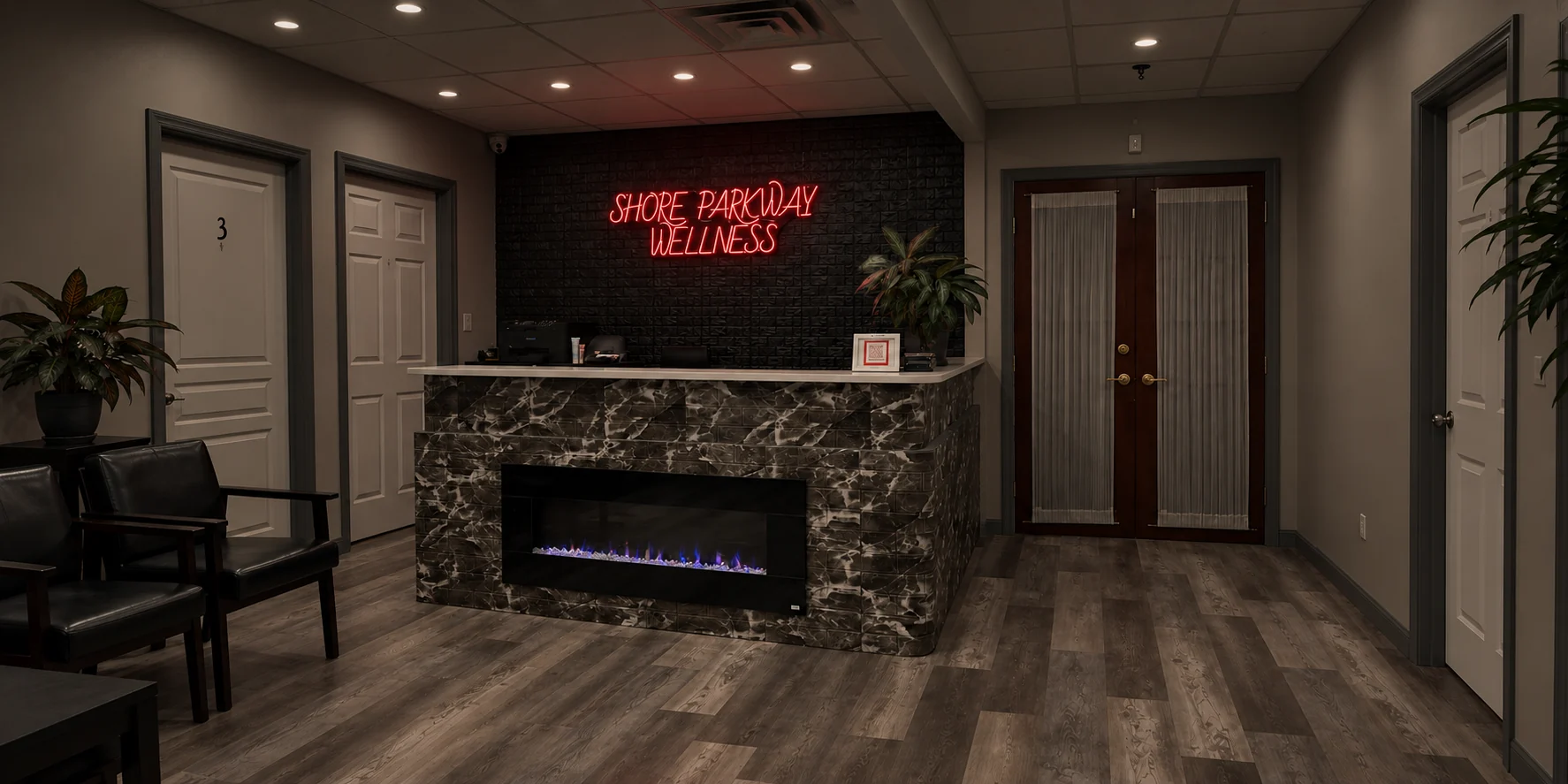 Shore Parkway Wellness reception with a red neon sign above a marble-front desk and fireplace
